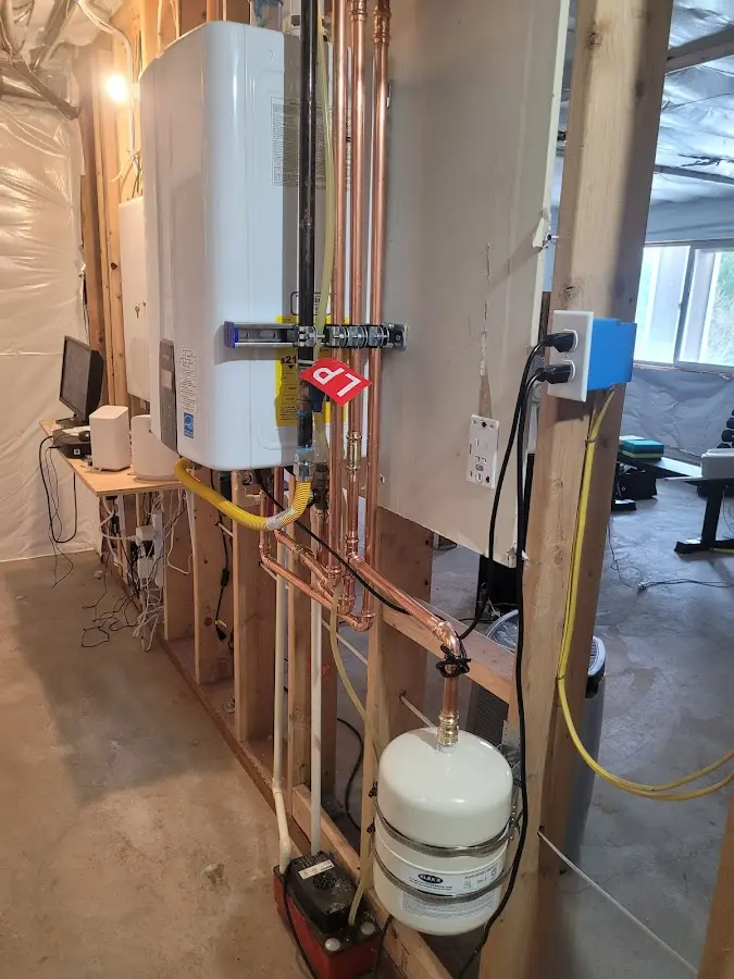 Licensed plumber repairing a kitchen sink in Two Rivers