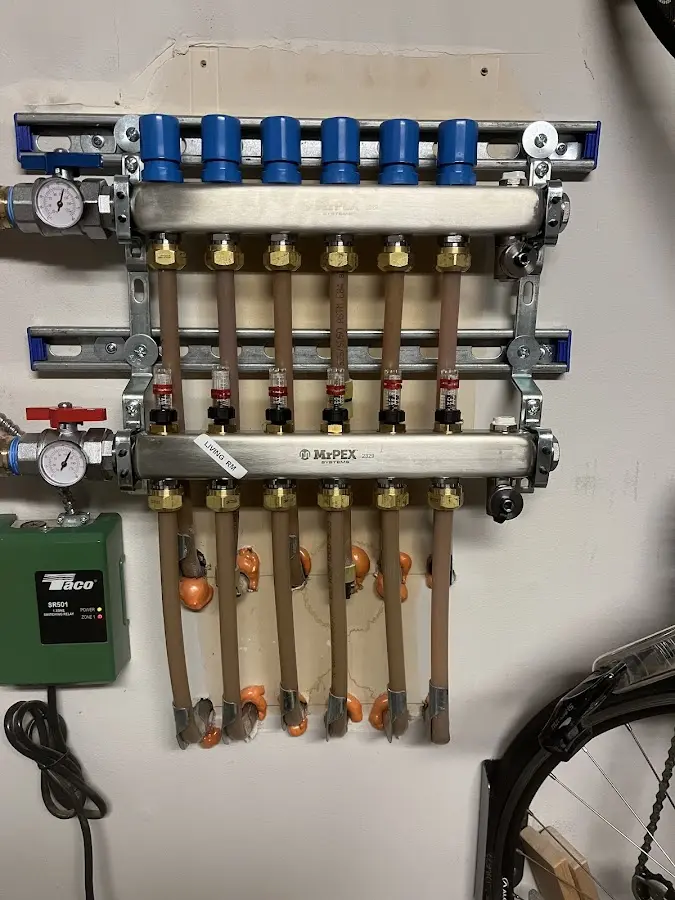 Plumber performing Water Heater Repair at a residential property in Two Rivers